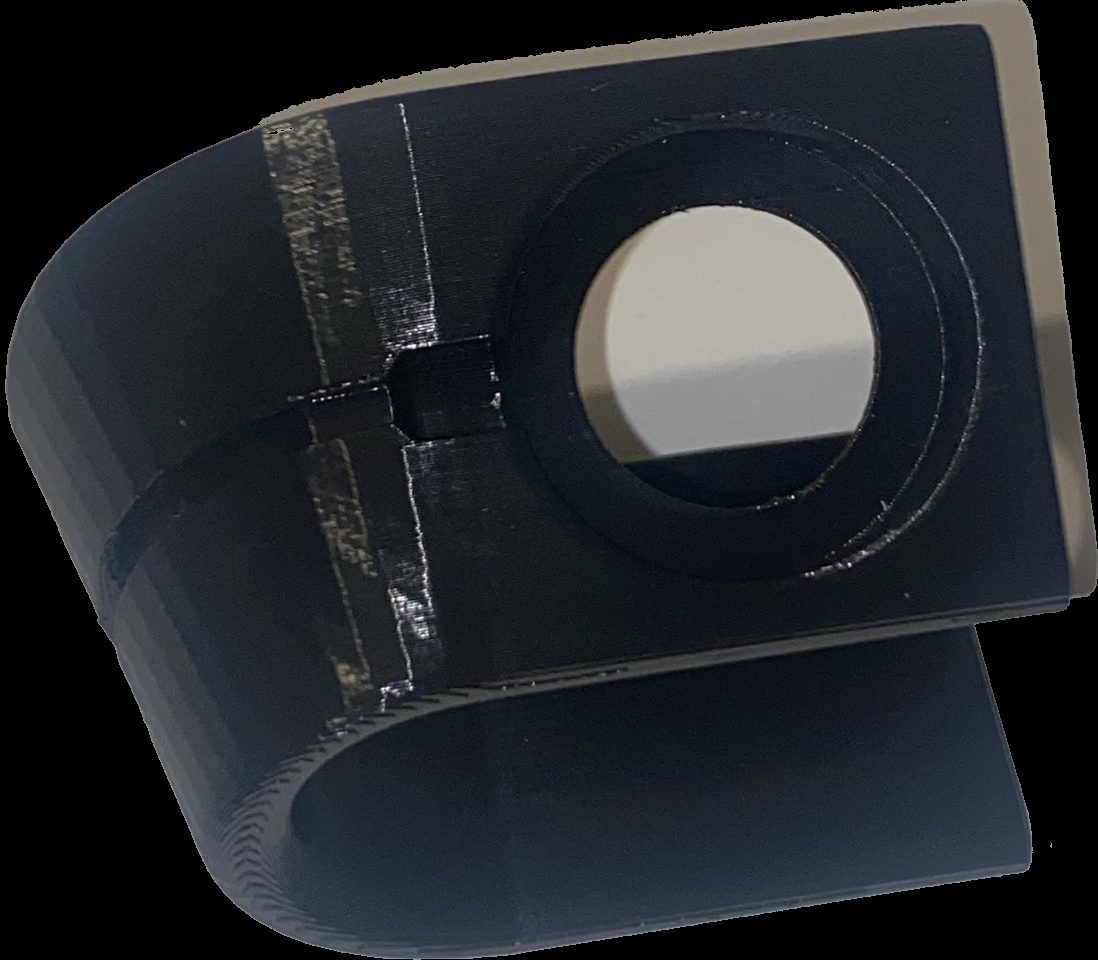 Load-bearing 3D-printed clip with hand-drawn sketch alongside, showing iteration from concept to production
