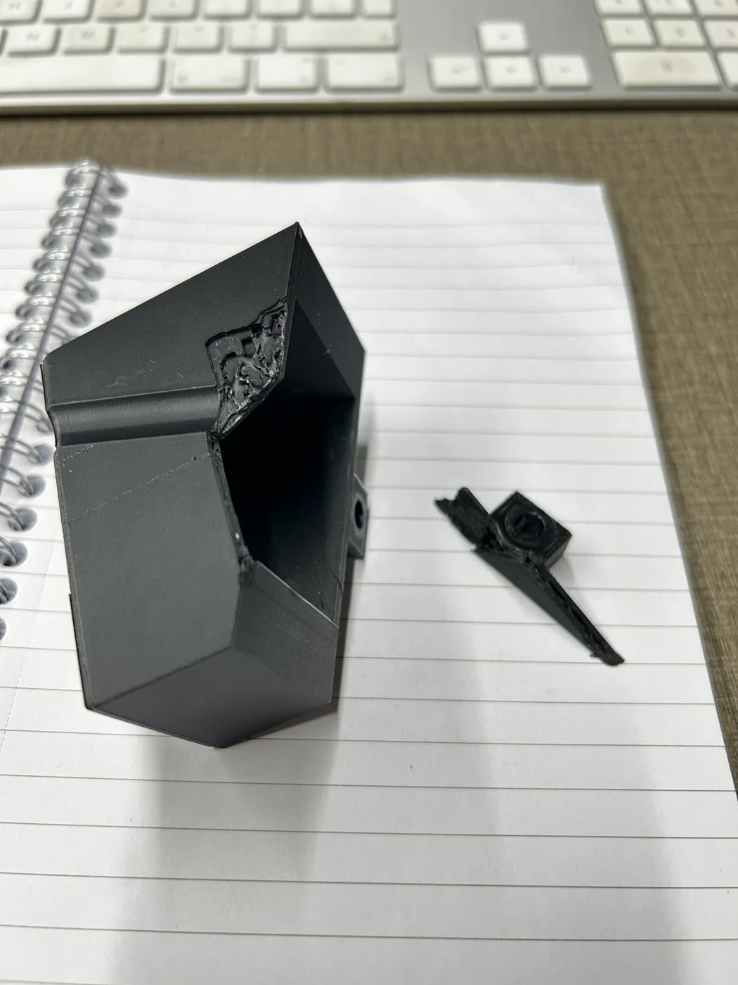 The printed PET-GF mount standing on the bench beside the small companion clip printed for the same Beryl job