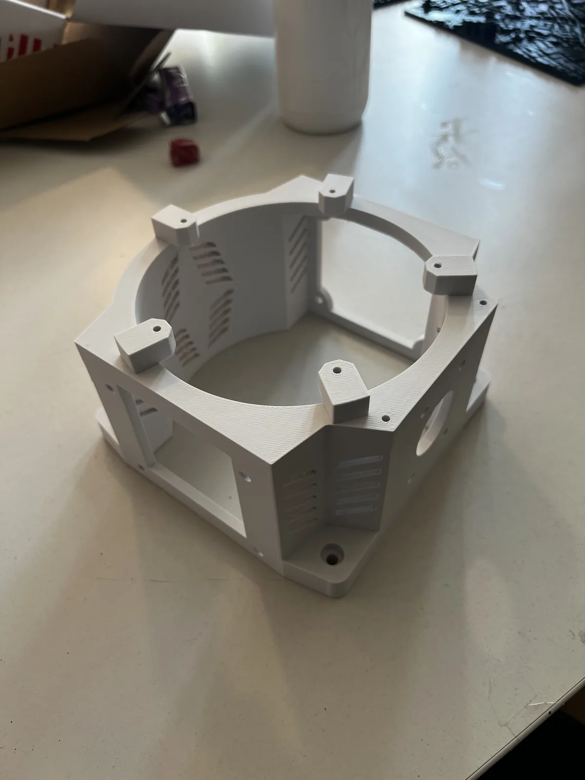 3D-printed vented base housing for the robotic arm, with cooling slots around the electronics bay, printed in heat-resistant ASA