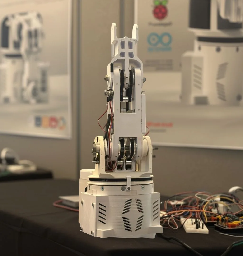 A white 3D-printed robotic arm and gripper built by Bournemouth University student Dan Slaney, on display at the Festival of Design and Engineering