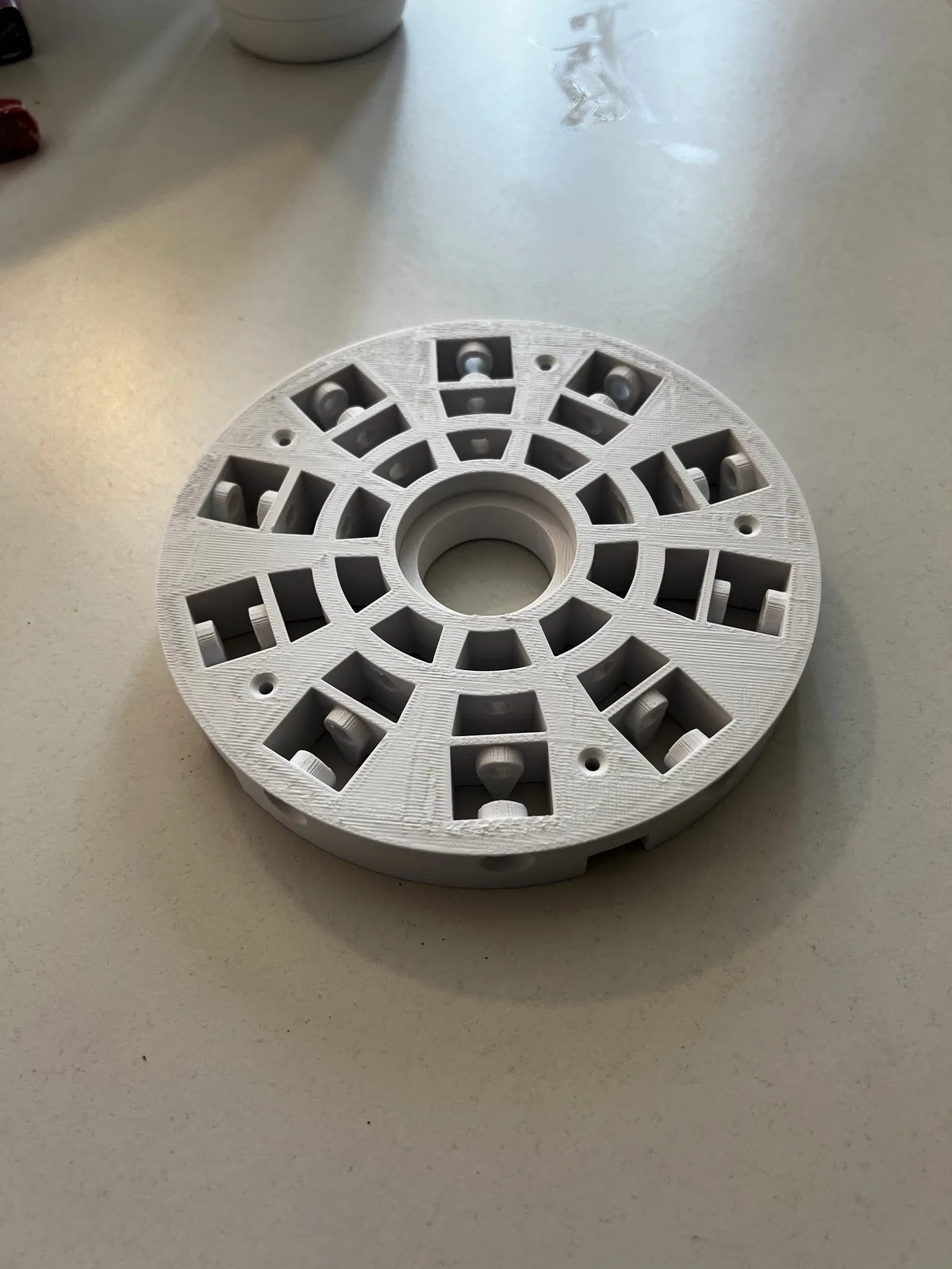 3D-printed circular turntable plate for the robotic arm base, ribbed for strength to carry the arm's weight
