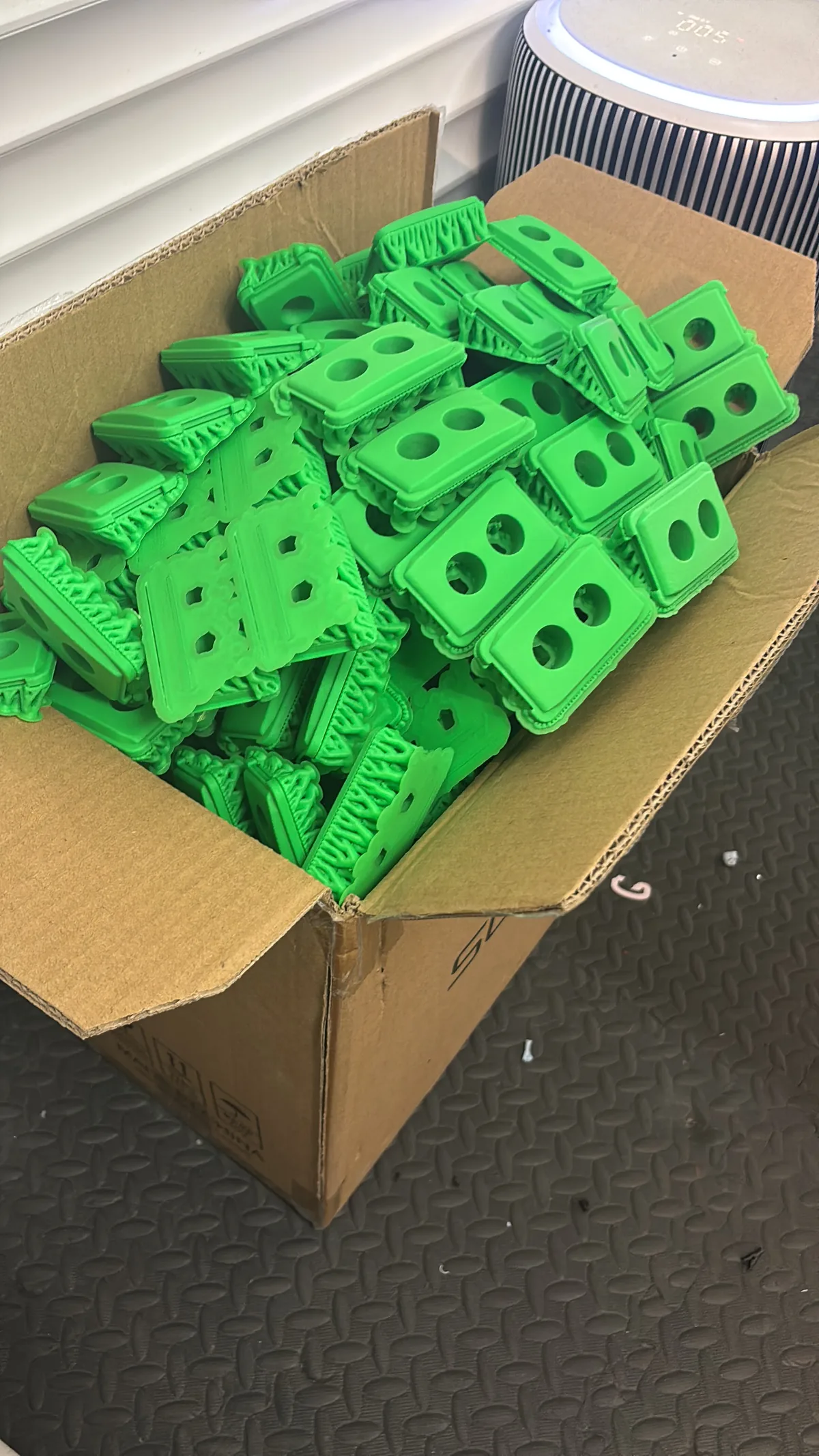 A box packed full of green mini DURABIN pen pots ready to ship for the show