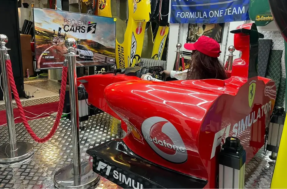 The finished 3D printed F1 racing simulator in red race livery at an event