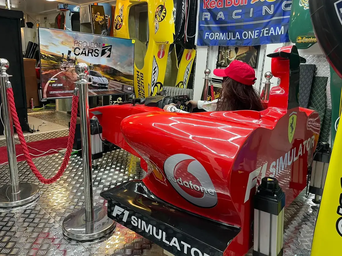A life size 3D printed F1 car built into a racing simulator, in full race livery, on an exhibition stand