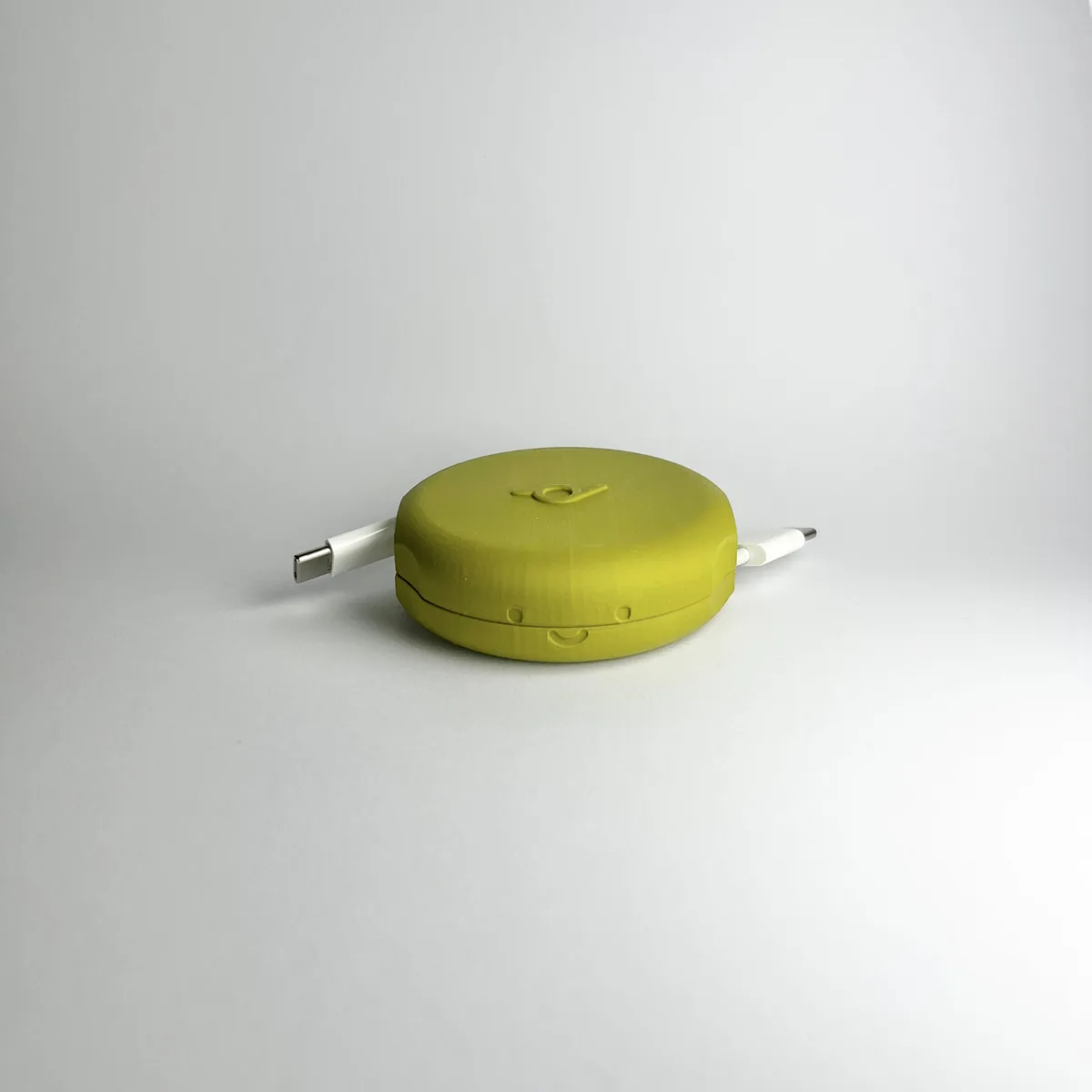 Mustard yellow Pebbl 1 Mini cable organiser, one of five colourways in production