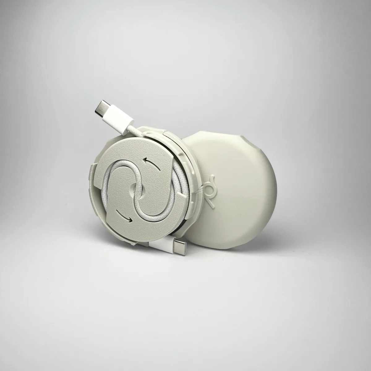 A Pebbl 1 Mini opened up to show the internal automatic cable winding mechanism