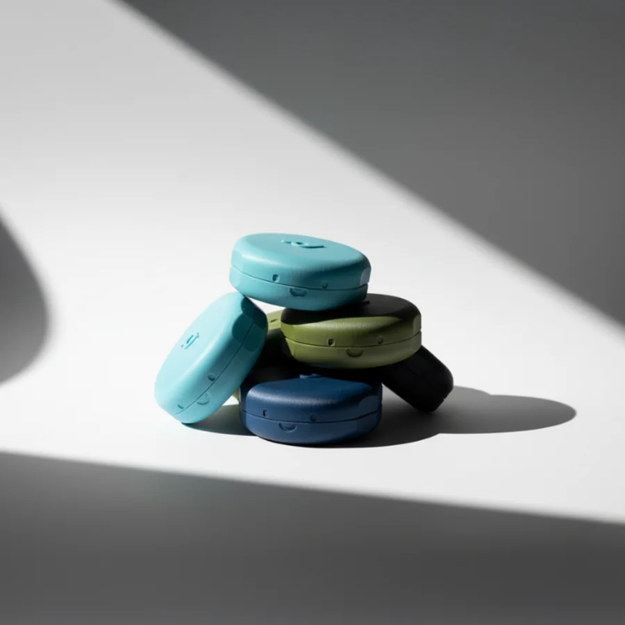 Pebbl cable organisers stacked in teal, olive, navy and black, made to order by 3D Printing Express