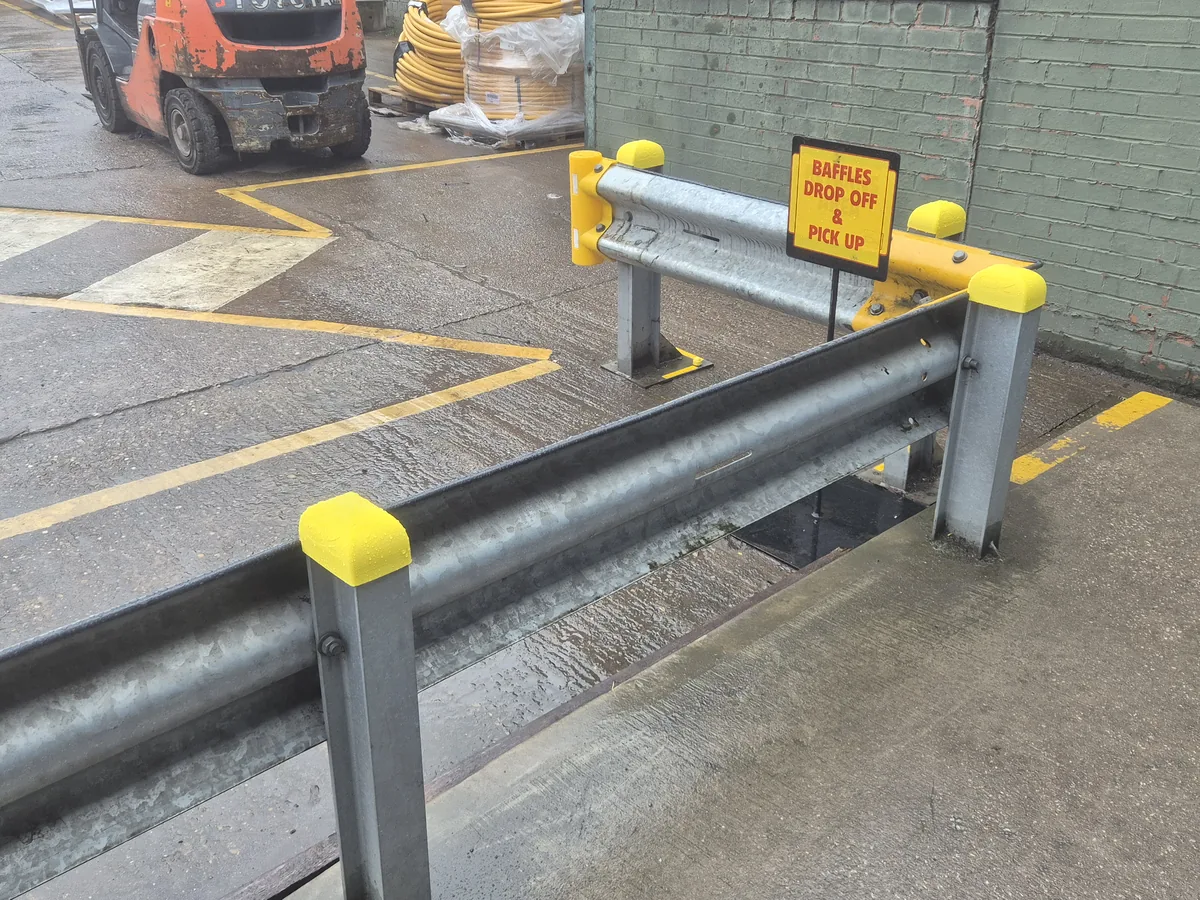 Yellow 3D-printed safety caps installed on galvanised Armco barrier ends at the Whale Tankers site