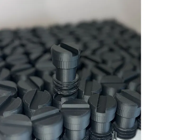 Array of identical 3D-printed knobs in a batch production run