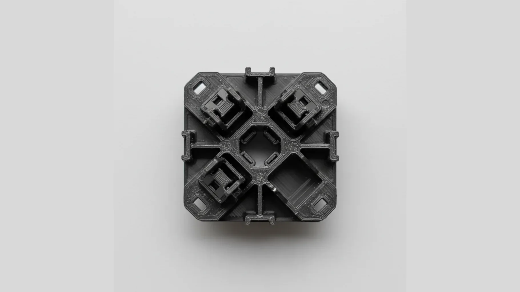 A single black 3D-printed PC-ABS automotive part with snap features