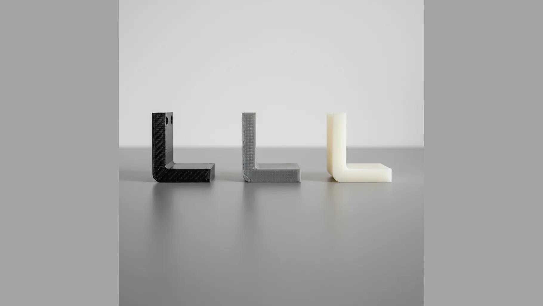 Three identical 3D-printed brackets shown to compare PA12-CF