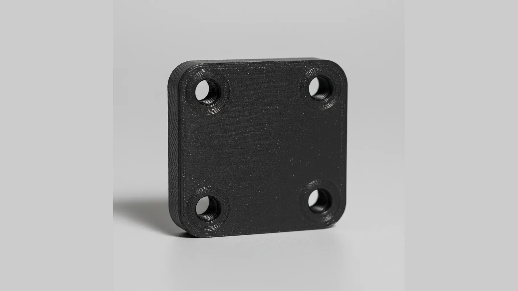 A single 3D-printed PA612-CF structural bracket with precise bolt holes