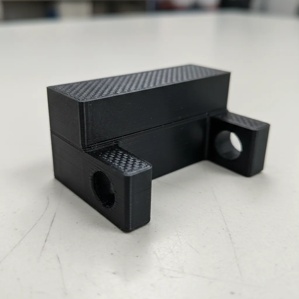 Macro photo of a 3D-printed PET-CF carbon-fibre composite engineering bracket