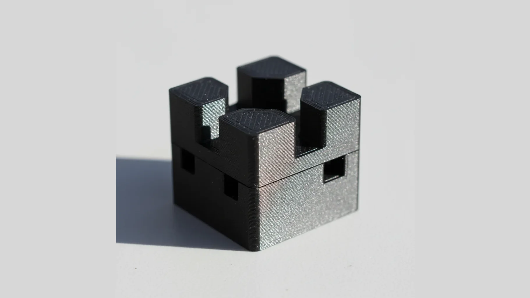 A single black 3D-printed PETG-ESD locating fixture