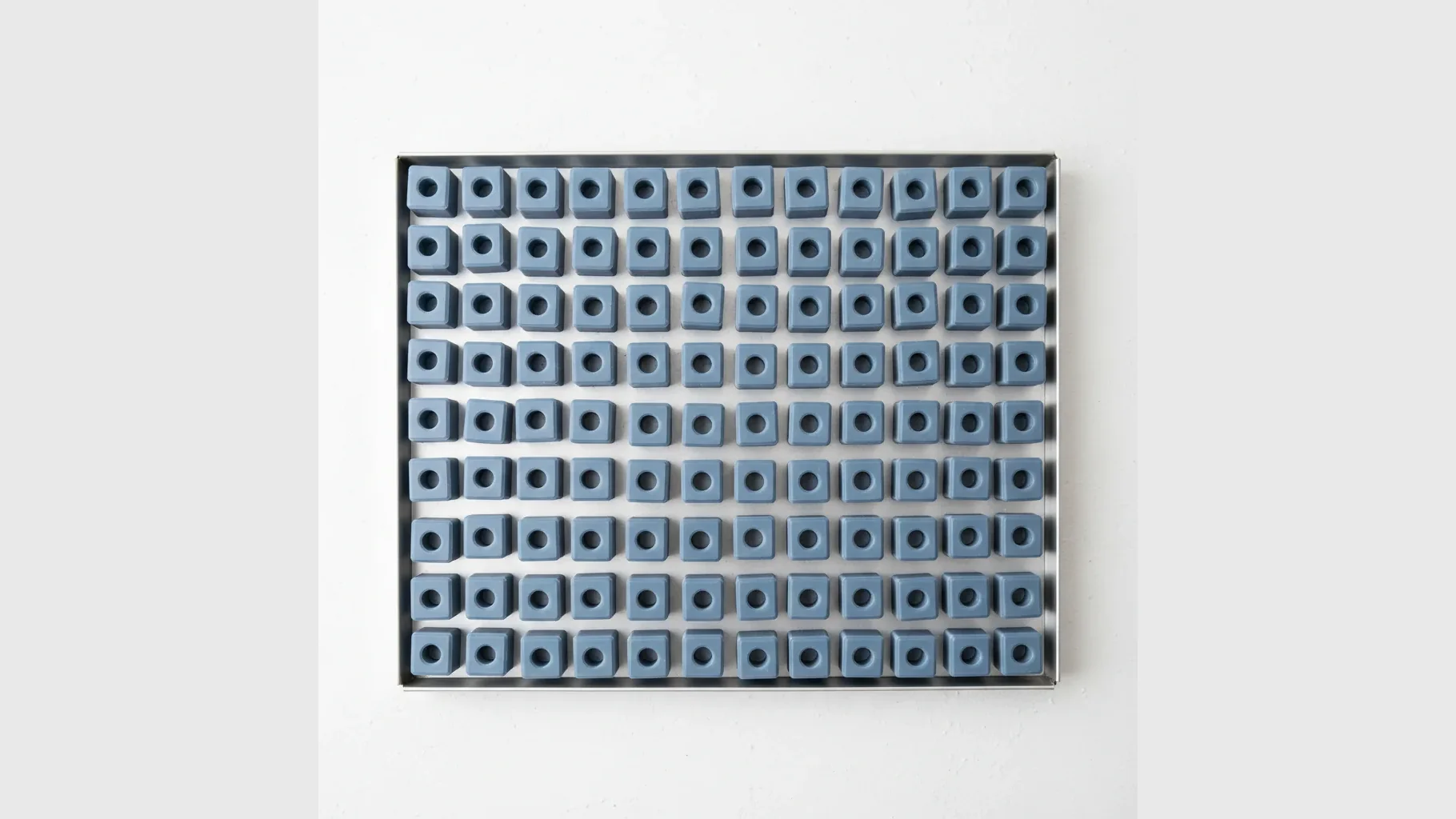 A neat tray of identical matte PLA-Matte parts
