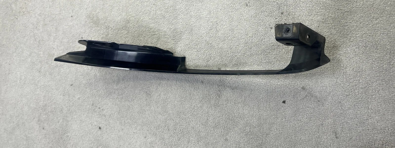 A Citroen Berlingo trim strip laid out on the floor, the reference part for a reverse engineering enquiry